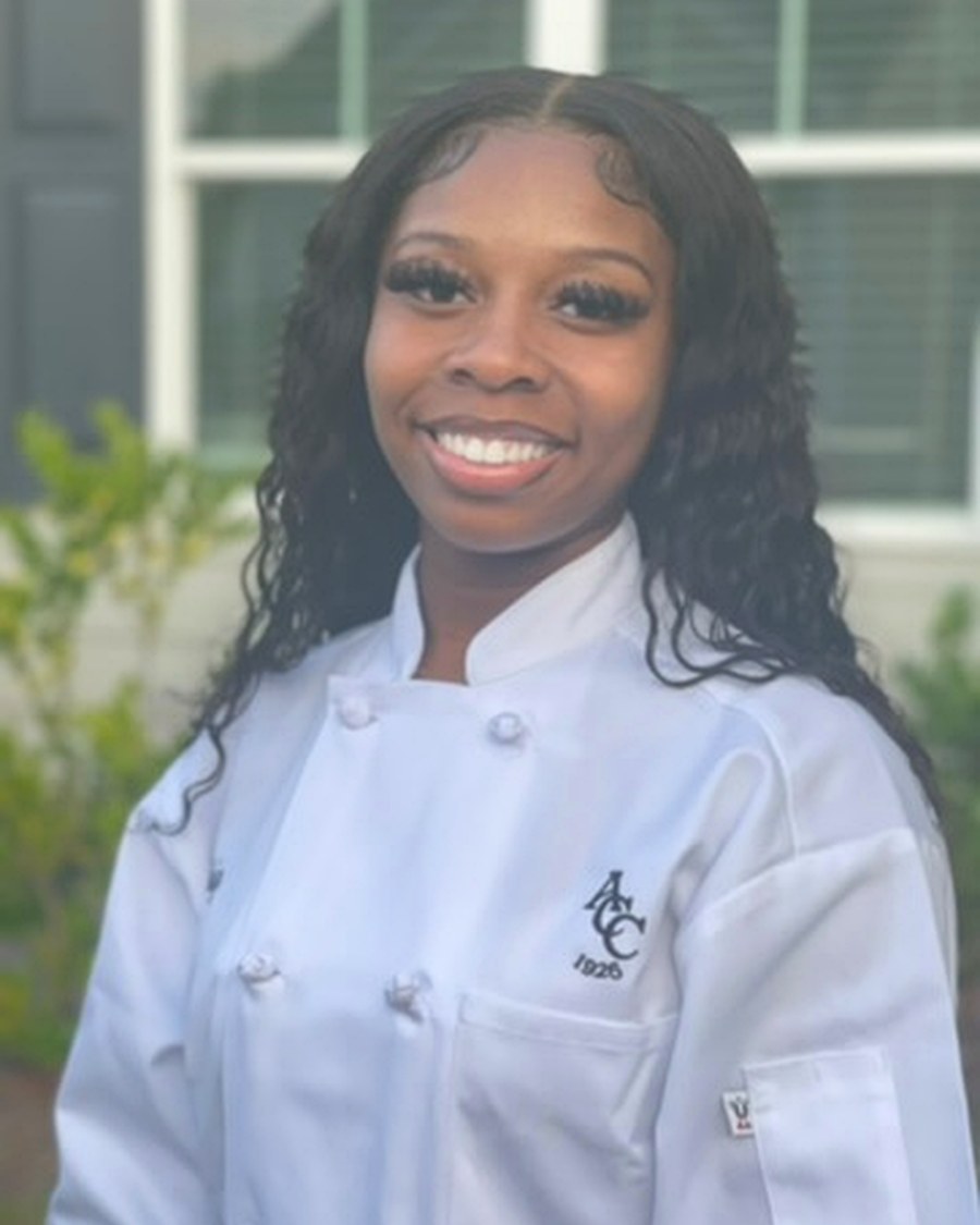 Chef Aniya Marie smiling in a white chef coat